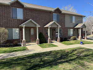 Red brick and tan siding exterior with gabled entryways