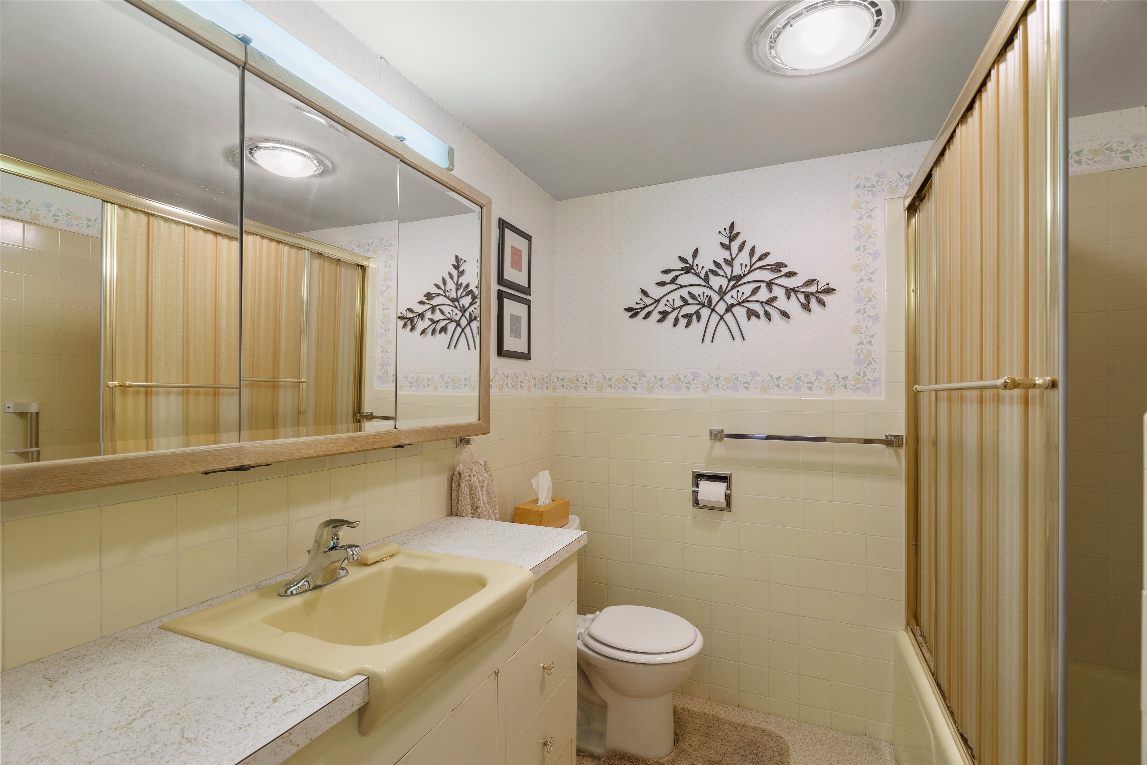 Bathroom featuring a built-in vanity with a yellow basin, white laminate countertop, and chrome faucet