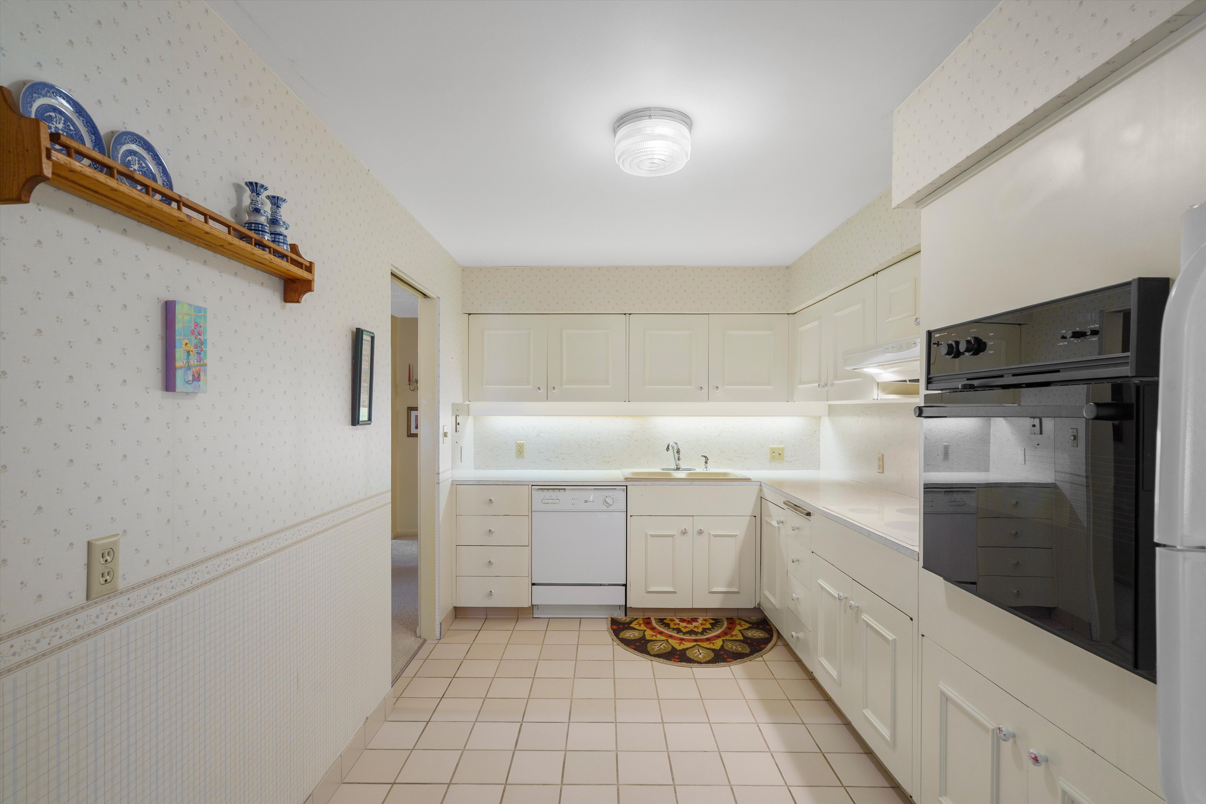 Kitchen featuring white cabinetry, light countertops, and ceramic tile flooring
