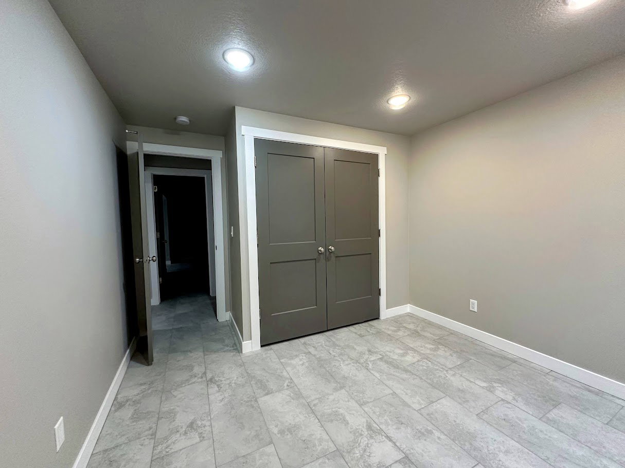 Neutral-toned interior room featuring light gray walls and white trim