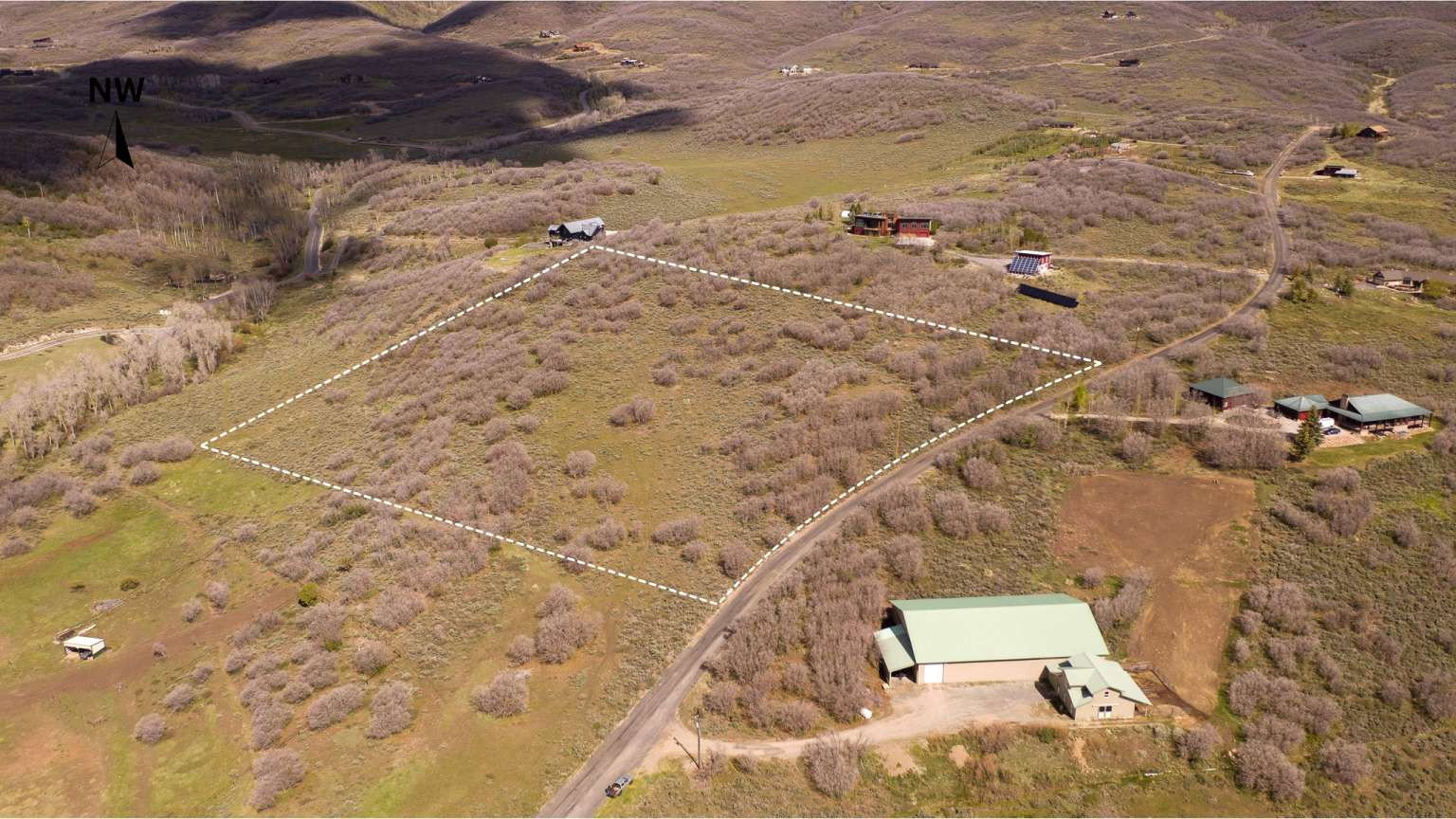 Expansive undeveloped land featuring natural foliage and a dirt road