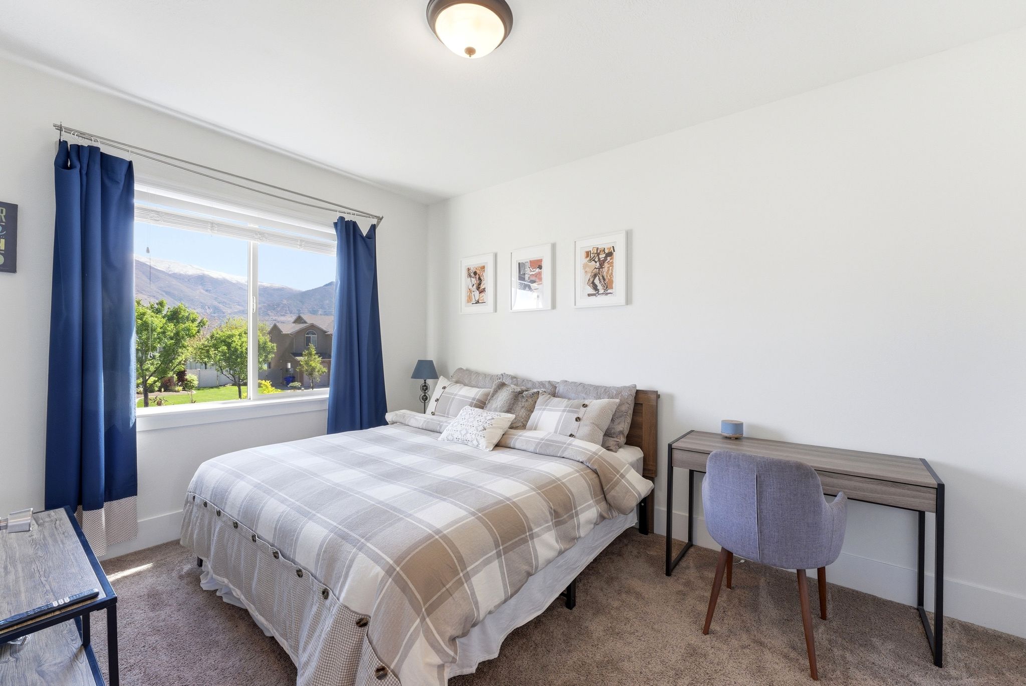 Carpeted bedroom featuring baseboards and a mountain view