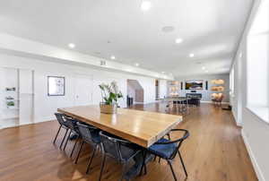 Dining space with dark wood-style flooring and recessed lighting