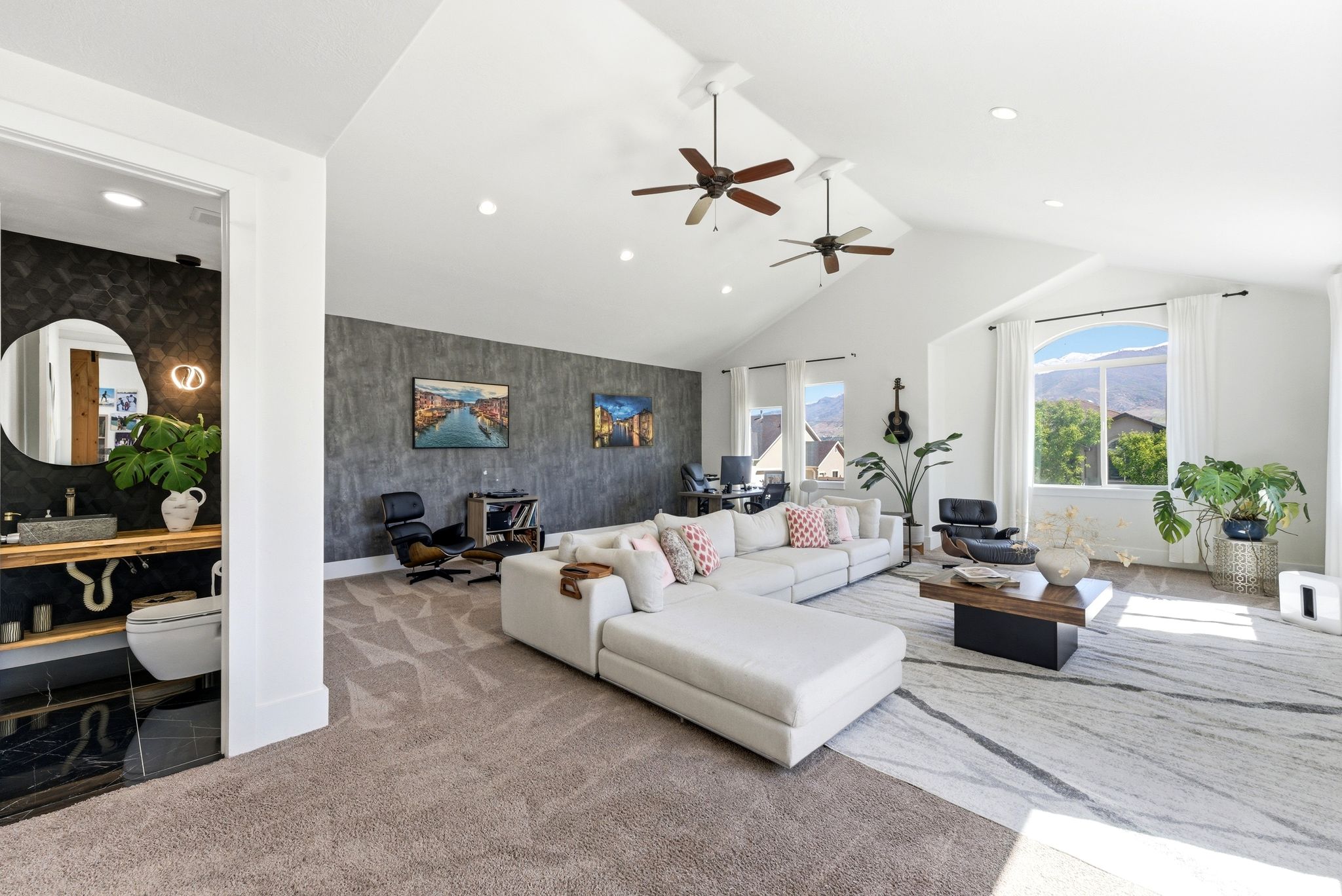 Carpeted living room featuring an accent wall, a high ceiling, recessed lighting, wallpapered walls, and ceiling fan