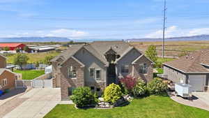 Craftsman house with a mountain view, a gate, stone siding, stucco siding, and brick siding