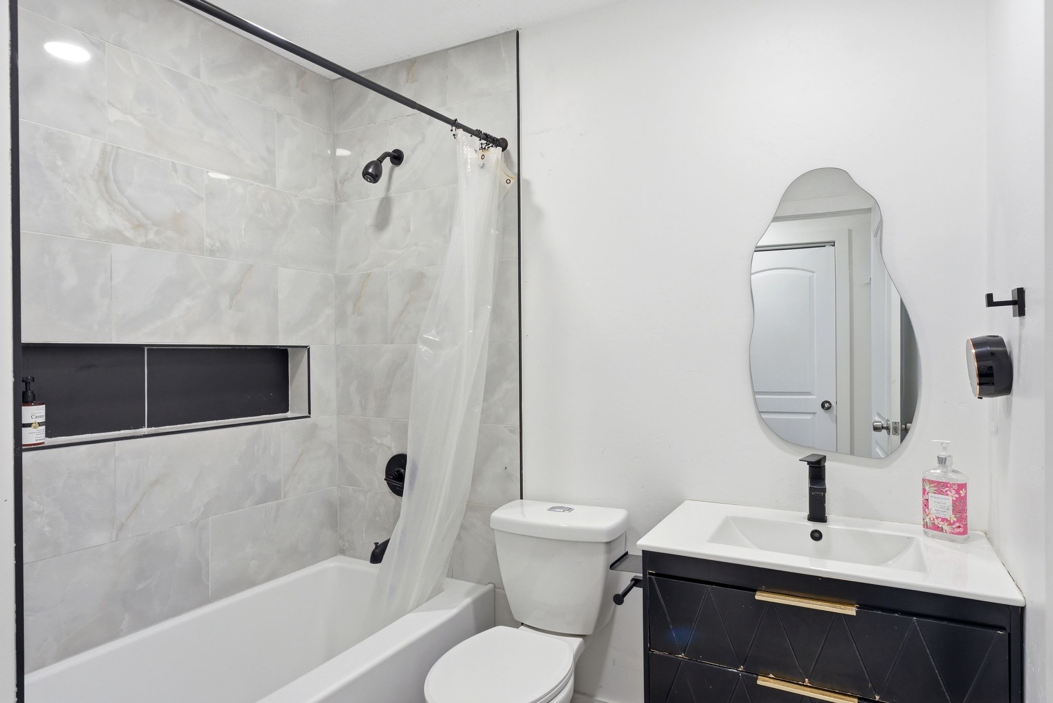 Bathroom with vanity and shower / tub combo with curtain