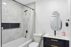 Bathroom with vanity and shower / tub combo with curtain
