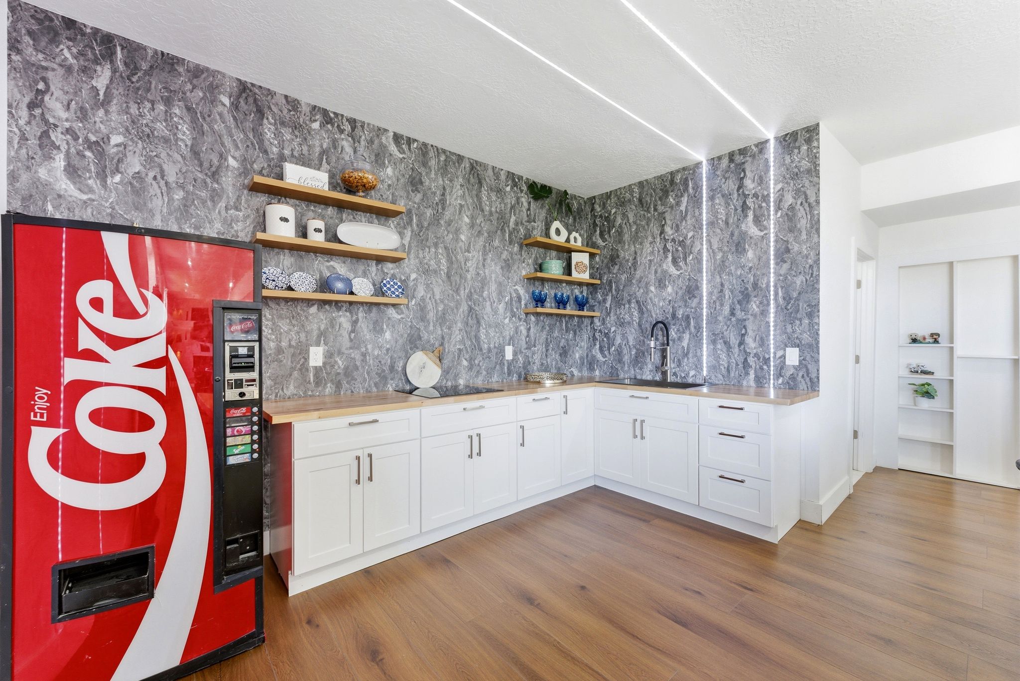 Bar area featuring open shelves, white cabinetry, wooden counters, dark wood-type flooring, and a textured ceiling