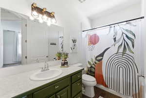 Bathroom featuring vanity and shower / tub combo with curtain