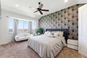 Carpeted bedroom with an accent wall, ceiling fan, lofted ceiling, wallpapered walls, and recessed lighting