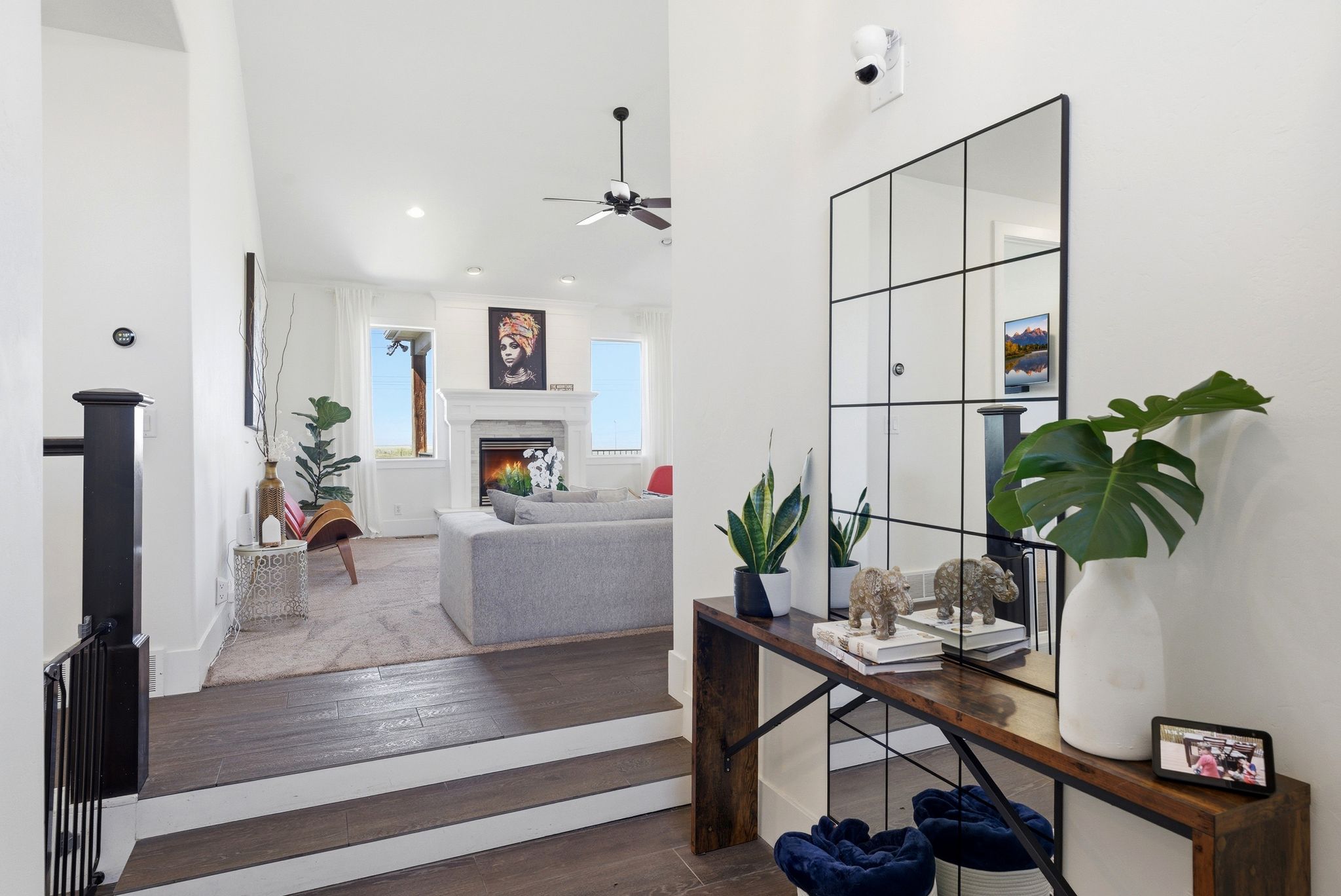 Office space with hardwood / wood-style floors, ceiling fan, and a premium fireplace