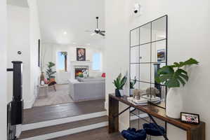 Office space with hardwood / wood-style floors, ceiling fan, and a premium fireplace