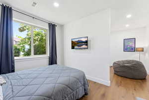 Bedroom featuring wood finished floors and recessed lighting