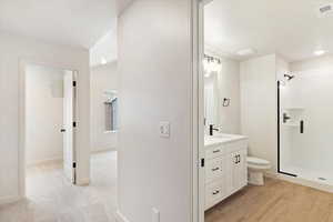Modern bathroom featuring a white vanity with black hardware, a rectangular undermount sink, and a black faucet
