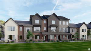 Modern townhome complex featuring a blend of vertical siding, brick accents, and horizontal siding