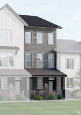 Three-story townhome featuring a dark gray roof, gray horizontal siding, and dark brick detailing