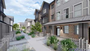 Modern townhome facades featuring brick and horizontal siding, multiple windows, and covered entryways