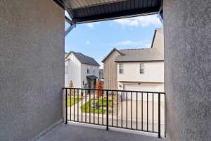 Outdoor balcony with concrete flooring and a black metal railing