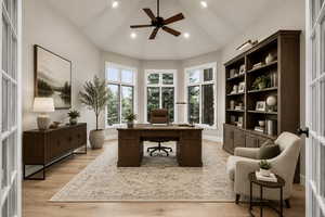 Vaulted ceiling study featuring a wood-finish ceiling fan and recessed lighting