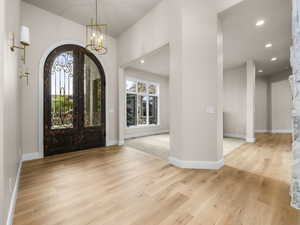 Arched double entry doors with decorative ironwork