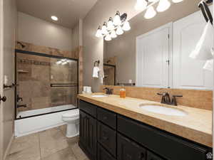 Dual vanity with dark wood cabinetry and integrated sinks, complemented by a light-toned countertop