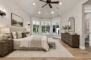 Vaulted ceiling with a wood-finish ceiling fan and recessed lighting