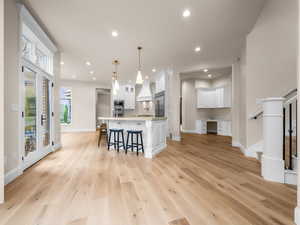 Open concept interior featuring light wood-finish flooring