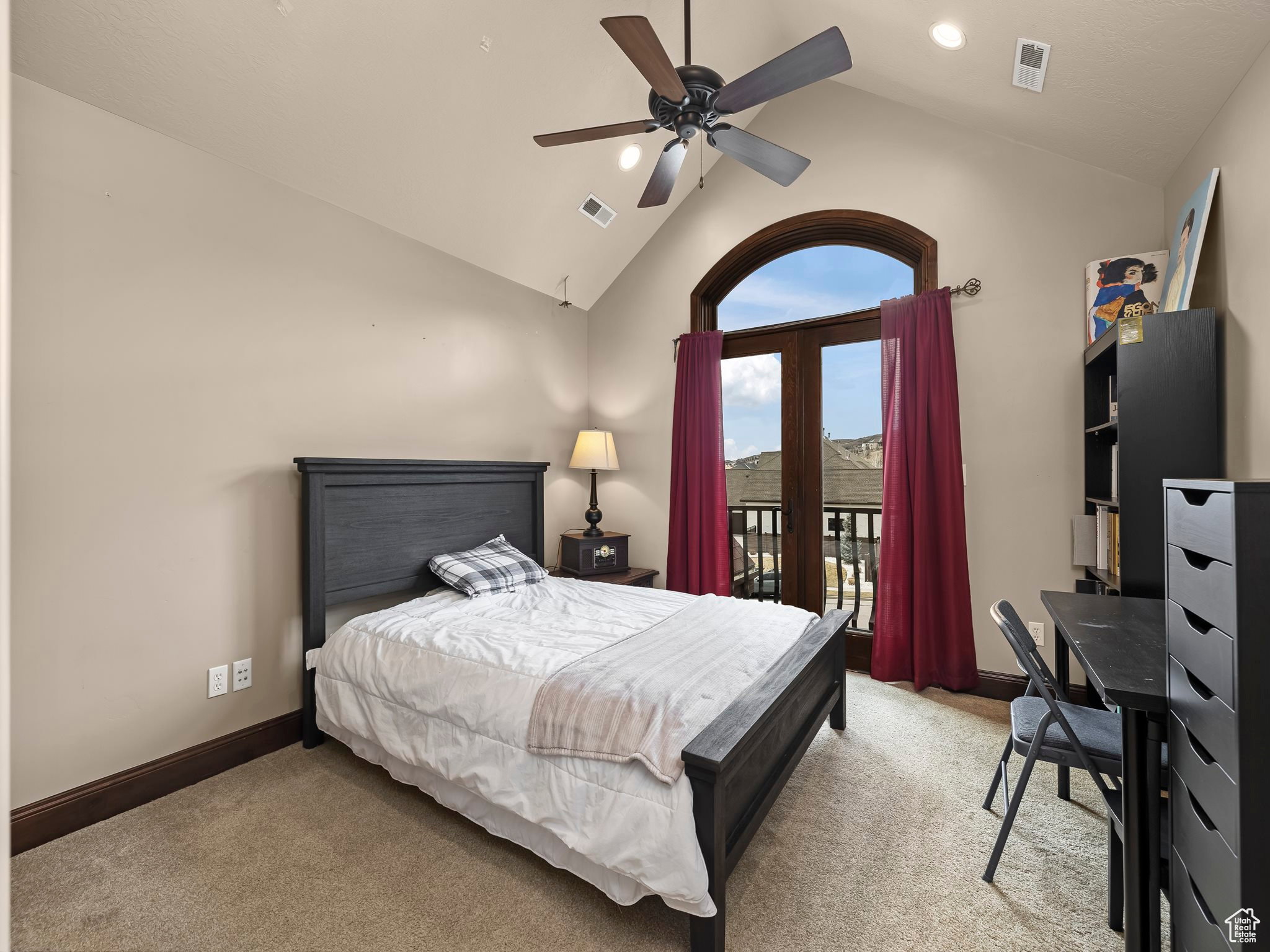 Carpeted room featuring a vaulted ceiling with a ceiling fan, recessed lighting, and an arched French door leading to an exterior balcony