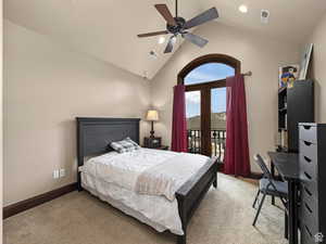 Carpeted room featuring a vaulted ceiling with a ceiling fan, recessed lighting, and an arched French door leading to an exterior balcony