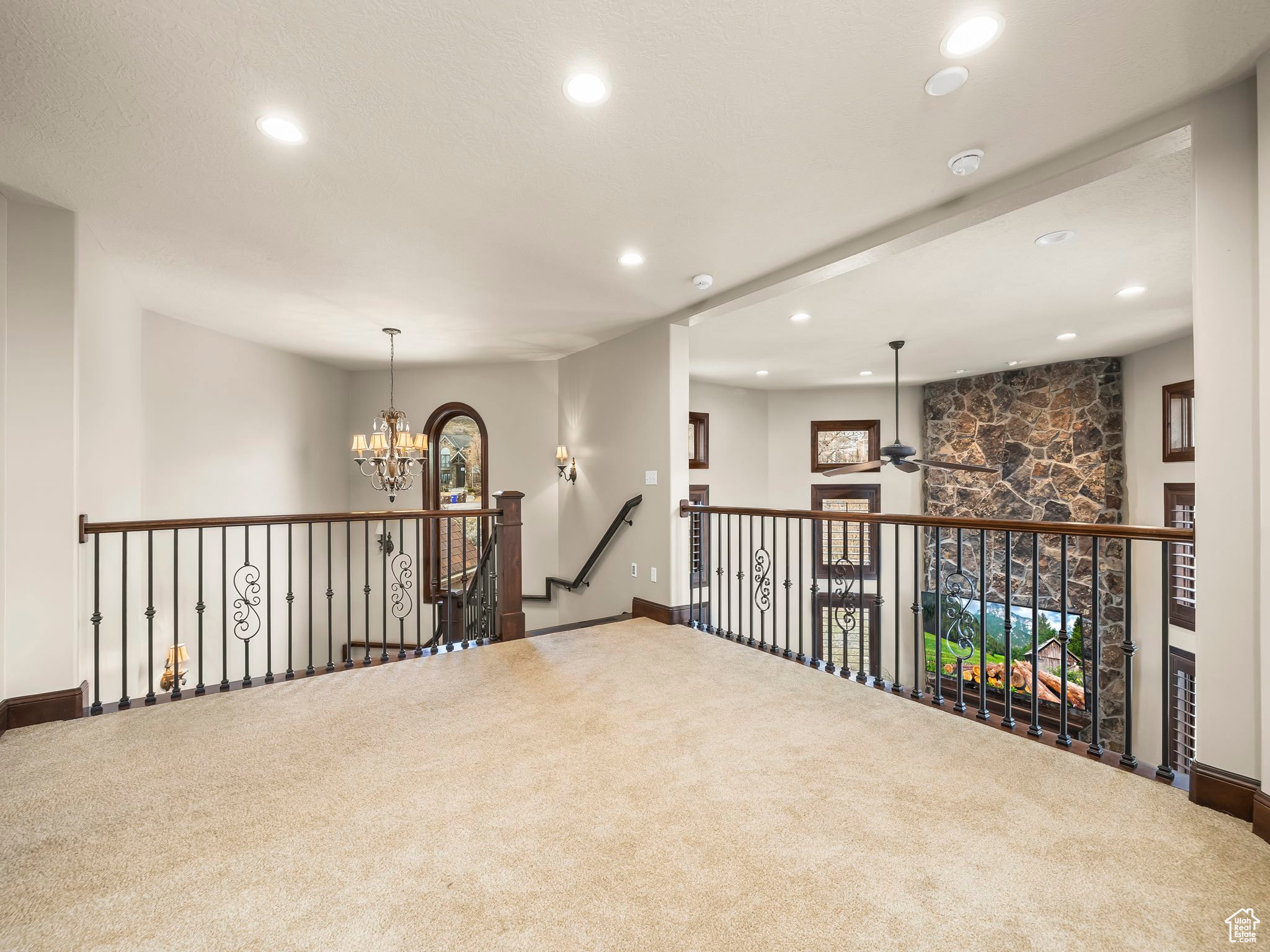 Spacious loft area featuring plush carpeting and recessed lighting