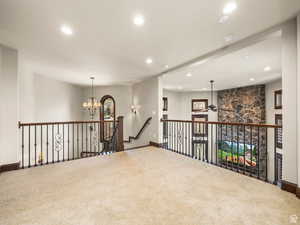 Spacious loft area featuring plush carpeting and recessed lighting