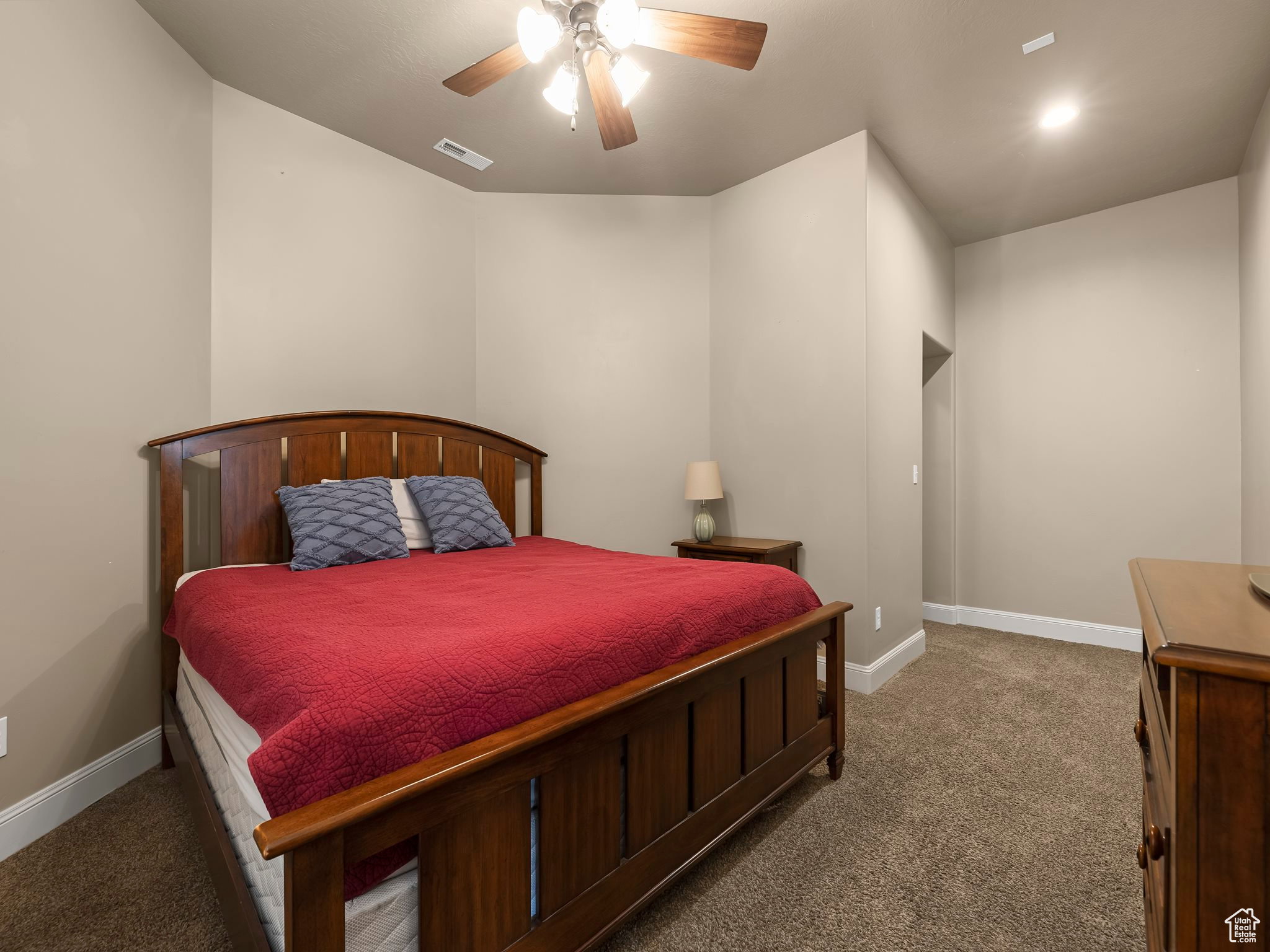 Carpeted room featuring a ceiling fan with light fixture, recessed lighting, and an alcove doorway
