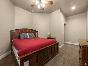 Carpeted room featuring a ceiling fan with light fixture, recessed lighting, and an alcove doorway