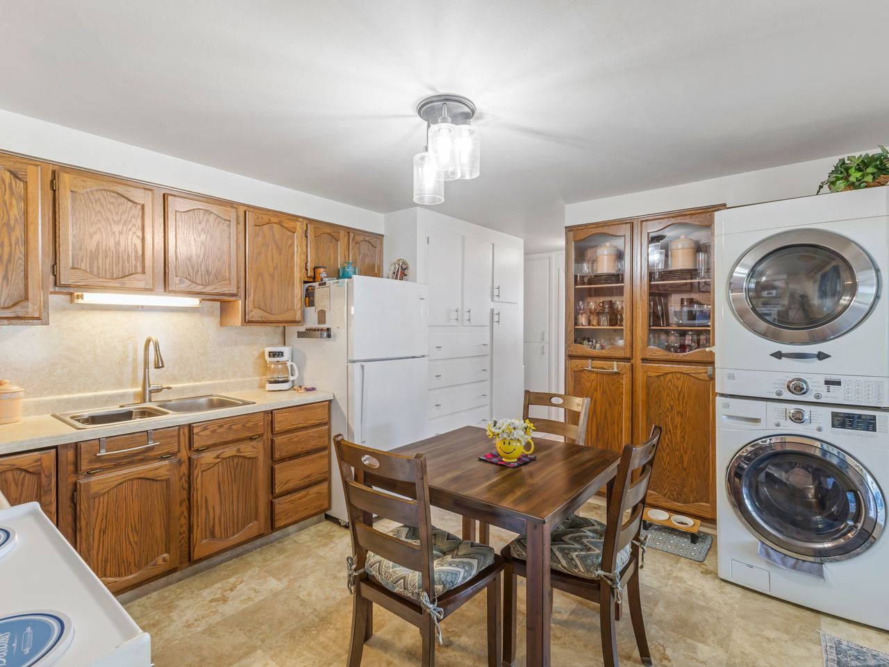Kitchen with wood-finish cabinetry, white countertops, and a dual basin stainless steel sink