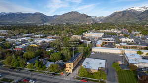 Aerial perspective of a multi-story building featuring a light-colored facade