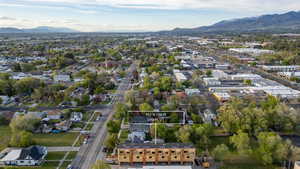 Aerial perspective showcasing the subject property amid a developed area with extensive tree cover