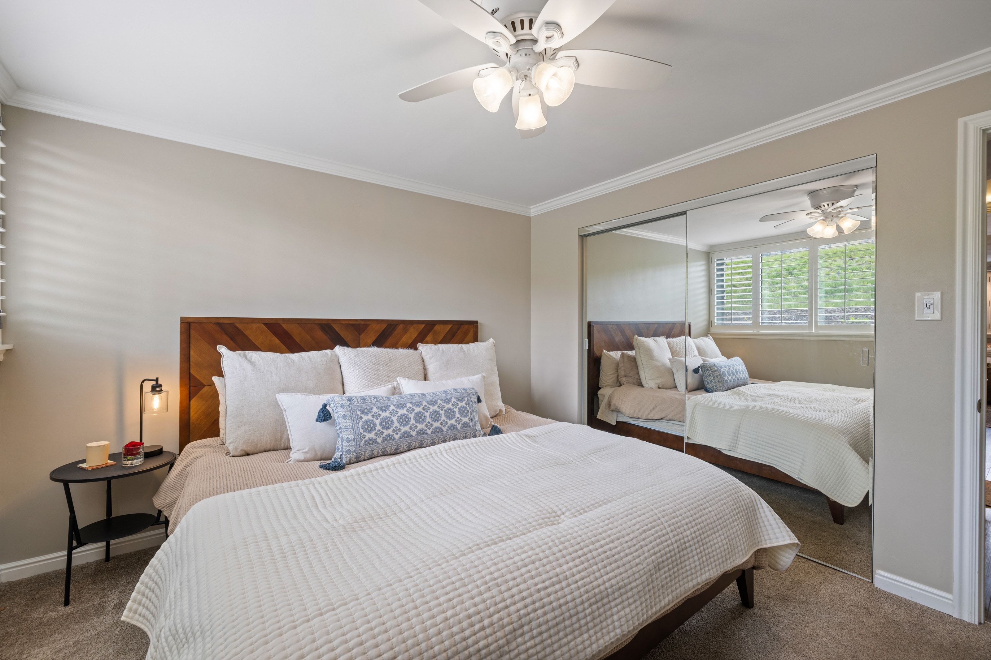 Neutral wall tones complement the crown molding and carpeted flooring