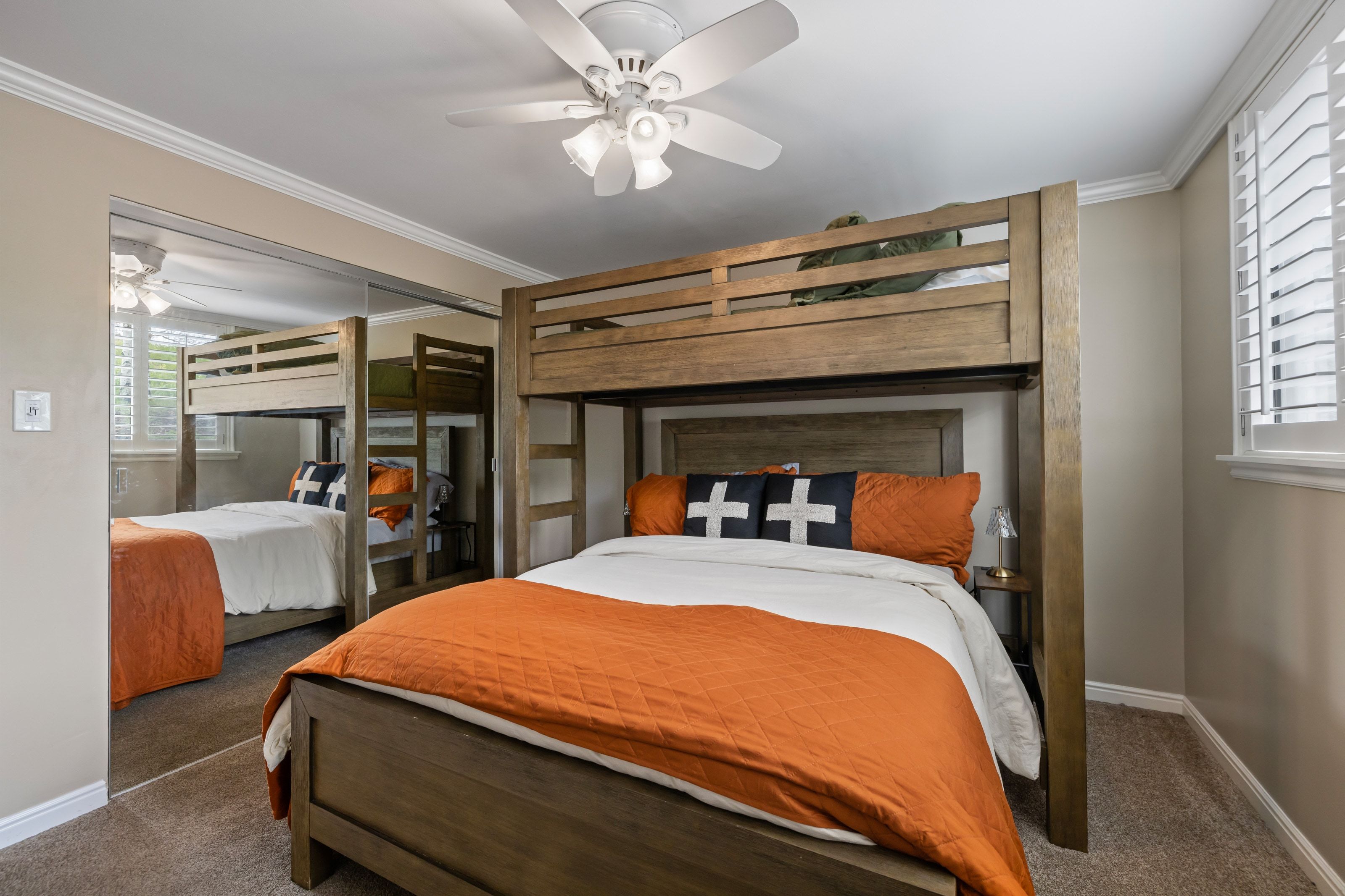 Carpeted room featuring a built-in bunk bed frame, crown molding, and a ceiling fan with light fixture