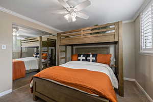 Carpeted room featuring a built-in bunk bed frame, crown molding, and a ceiling fan with light fixture
