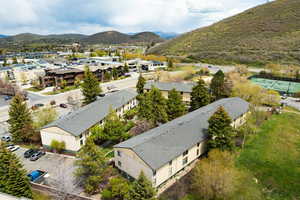 Multi-unit residential structures with sloped roofs and light-colored siding
