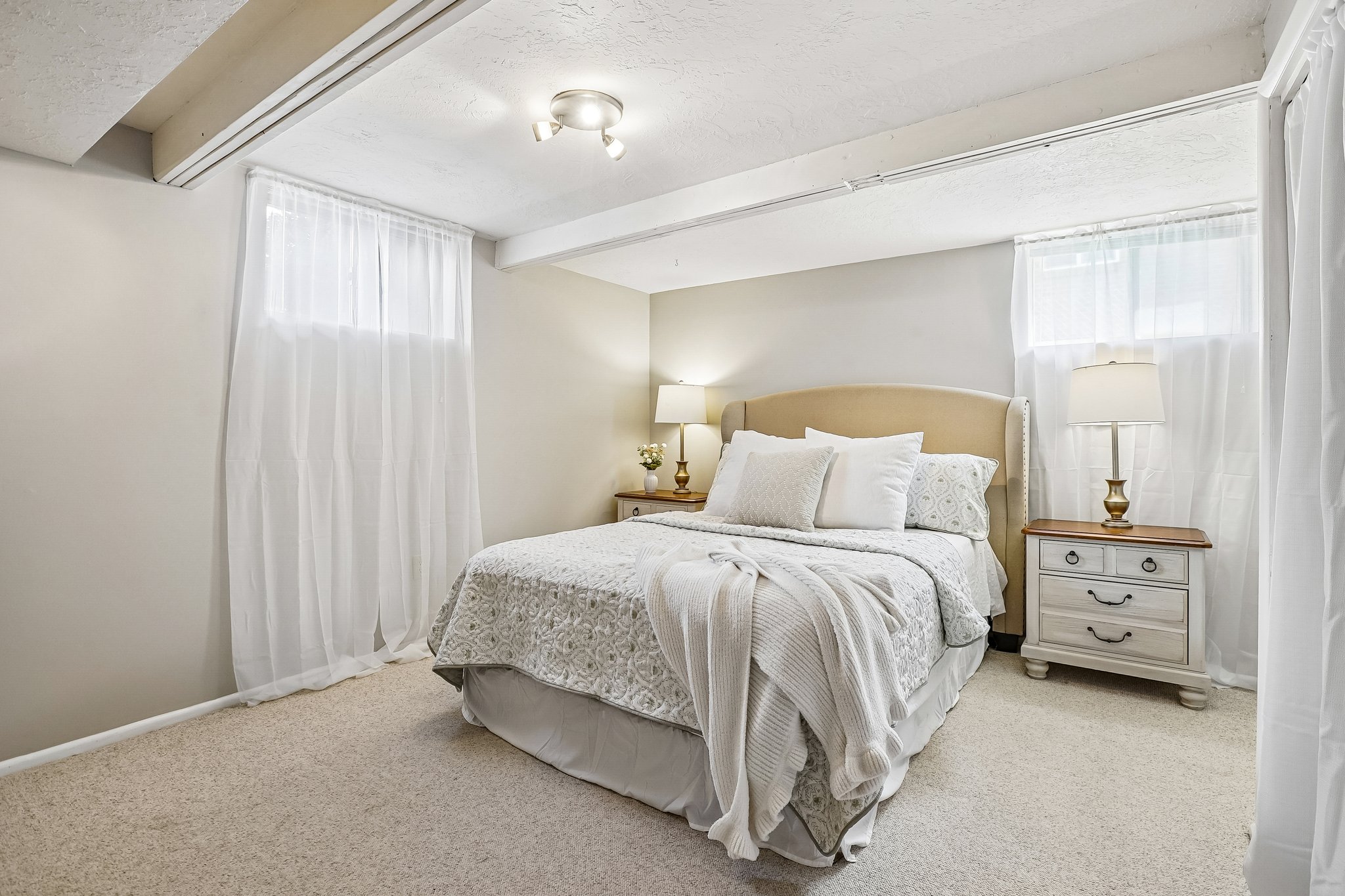 Carpeted room with exposed ceiling beams and recessed lighting