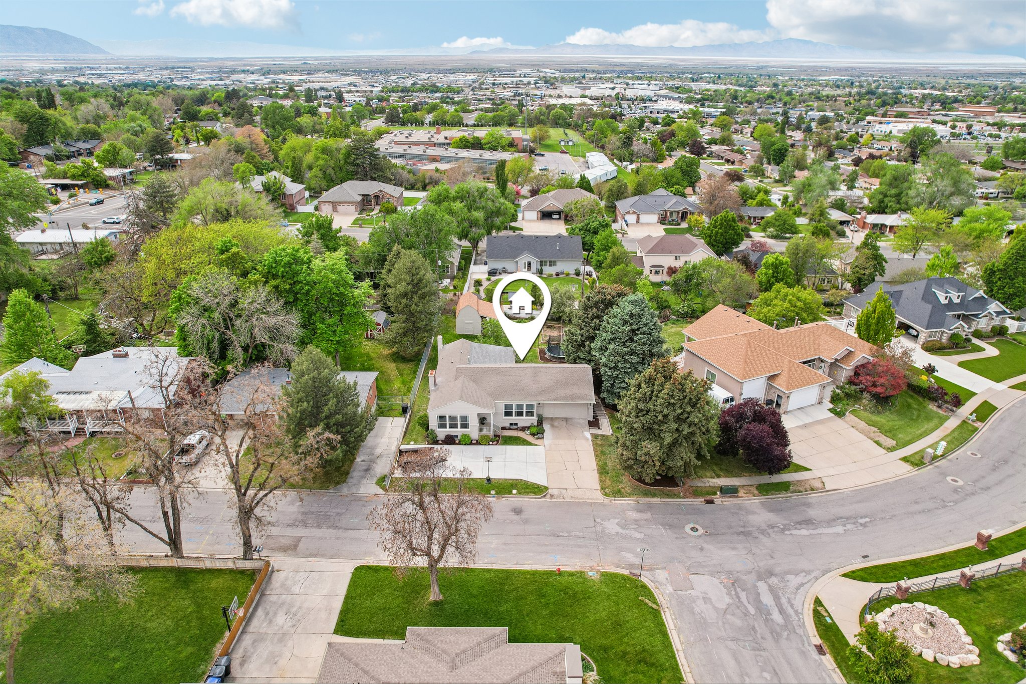 Single-story residence set on a spacious lot, featuring an attached two-car garage and a paved driveway
