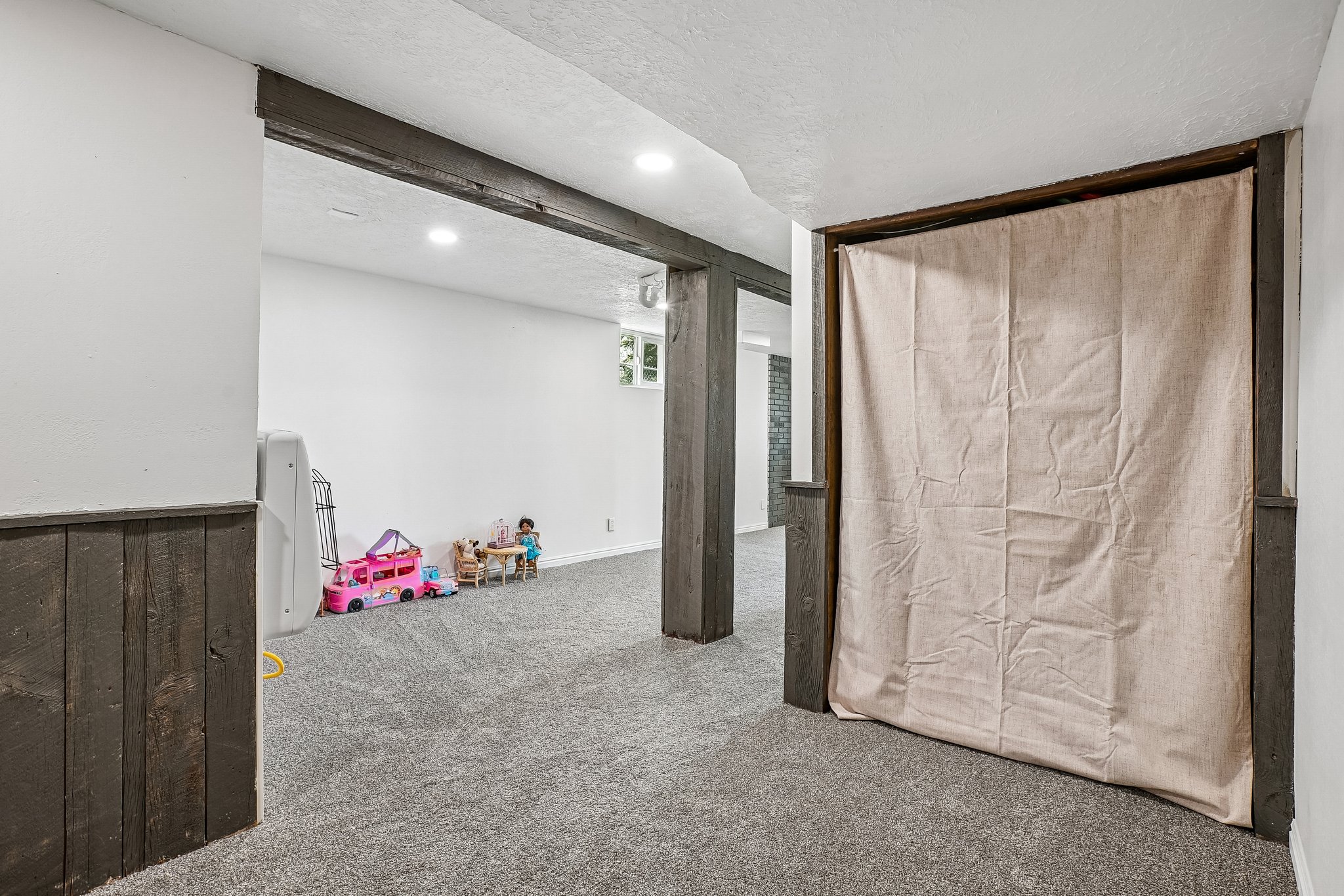 Finished lower level featuring recessed lighting, a window, and gray carpeting