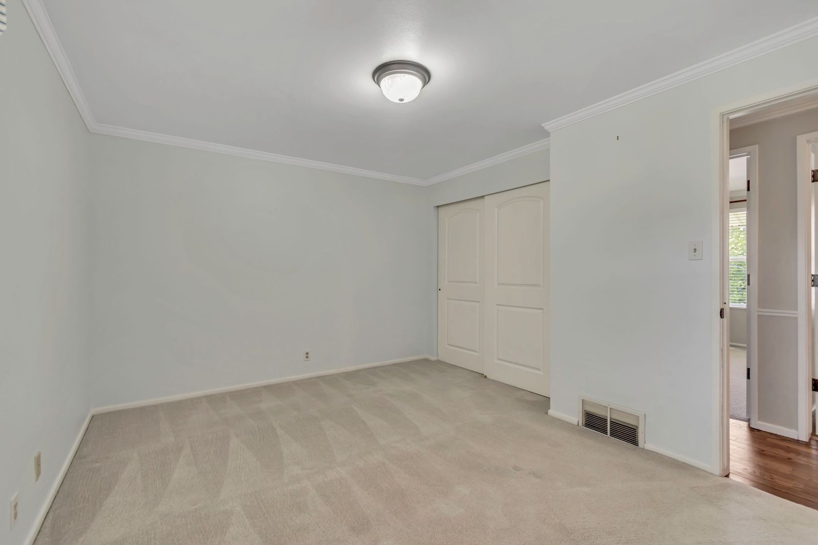 Neutral tone wall paint with white crown molding