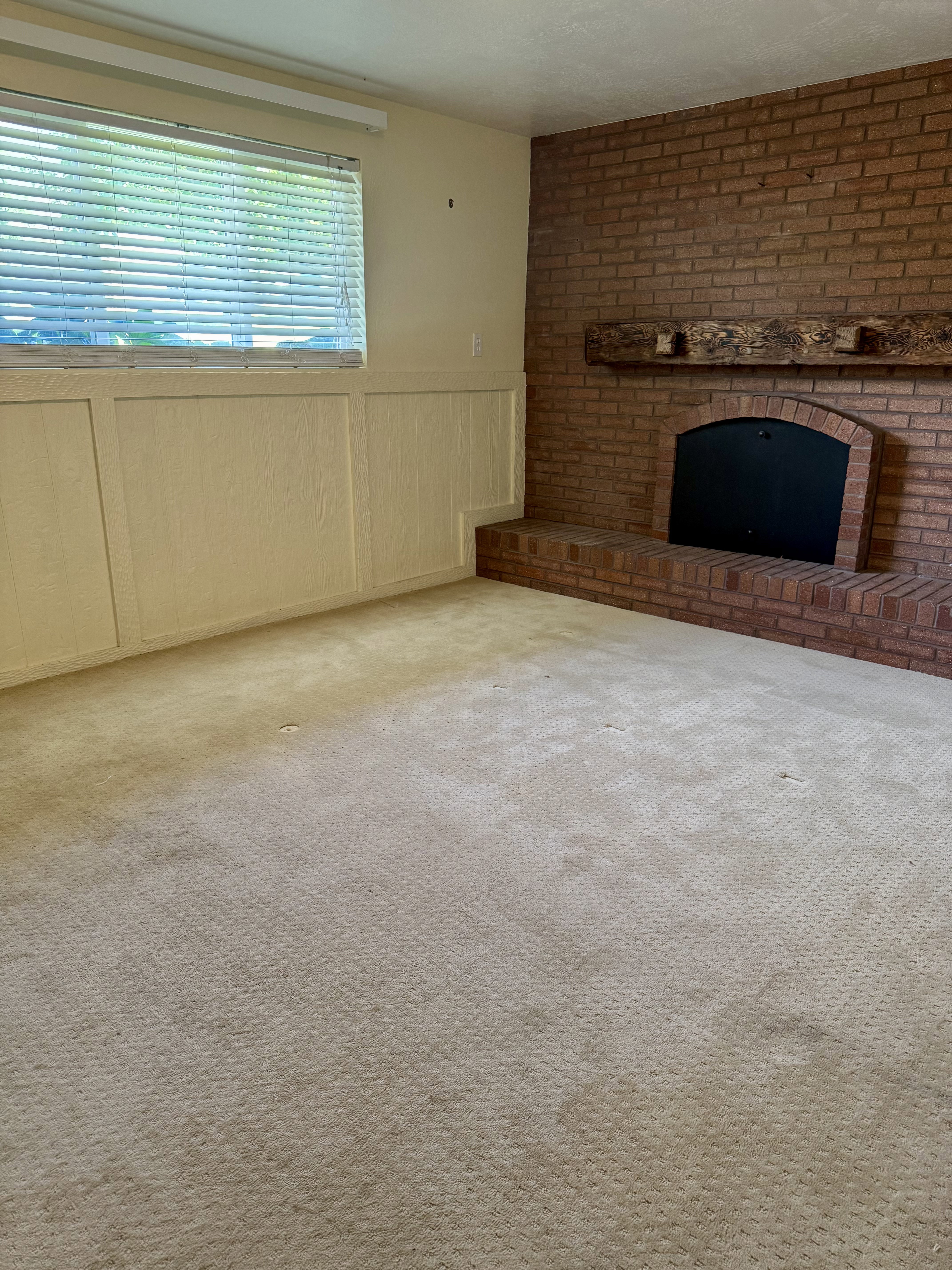 Brick fireplace with a substantial hearth and wood mantel