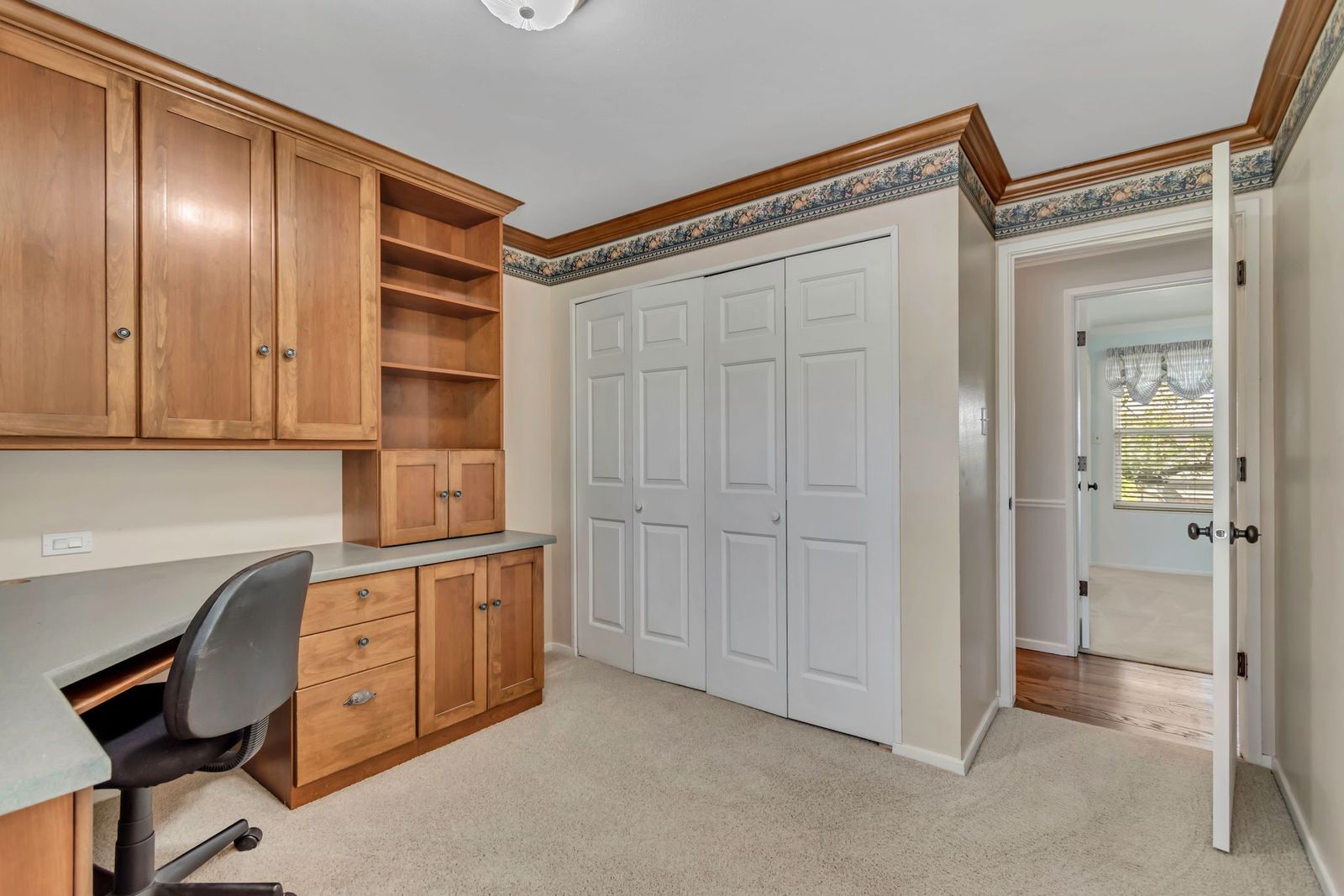 Built-in wood cabinetry and shelving with integrated desk space
