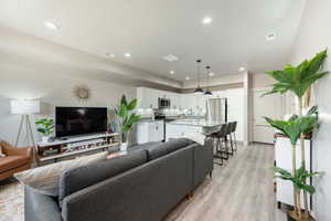 Open-concept living space featuring wood-finish flooring throughout