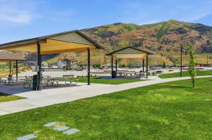Community park featuring multiple covered picnic areas and a paved pathway