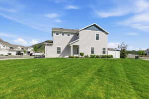 Contemporary two-story residence featuring light gray siding and a contrasting blue gable accent