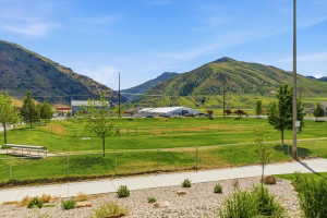 Expansive green space featuring a picnic area and mountain backdrop